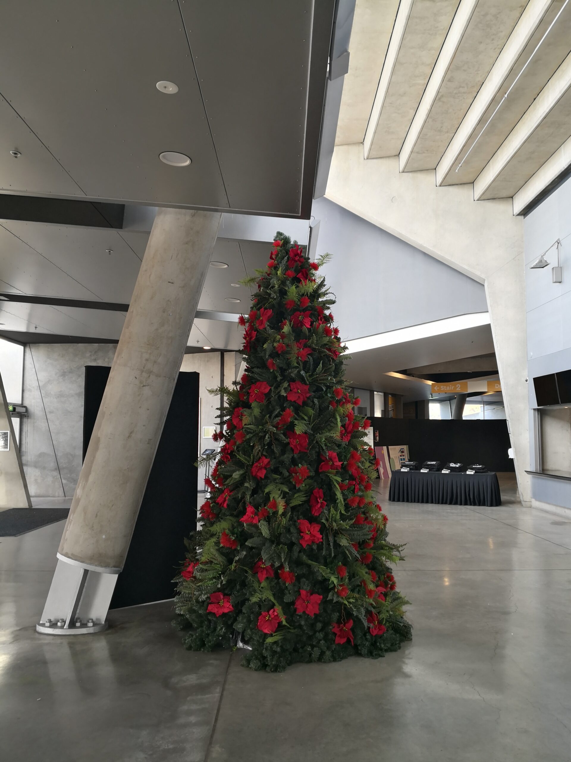 12‘ metal frame green christmas tree with poinsettia & fern decorations 12‘ metal frame green christmas tree with poinsettia & fern decorations