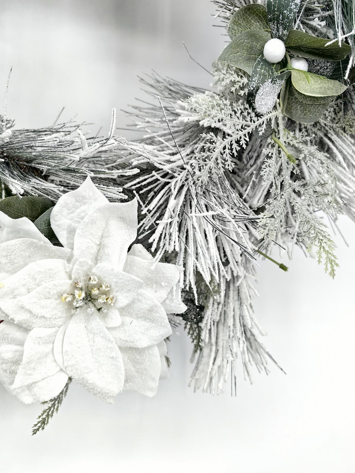 24" long snow needle pine wreath with poisettia flowers 24" long snow needle pine wreath with poisettia flowers