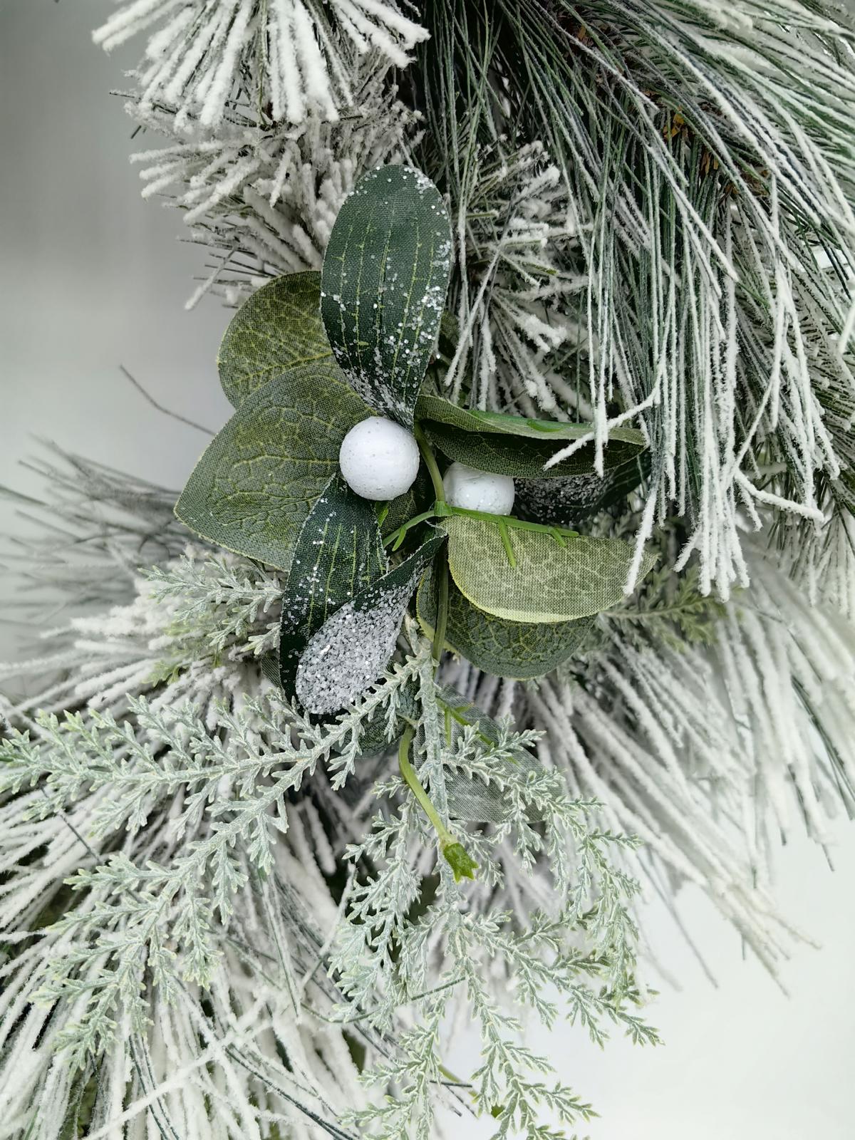 24" long snow needle pine wreath with poisettia flowers 24" long snow needle pine wreath with poisettia flowers