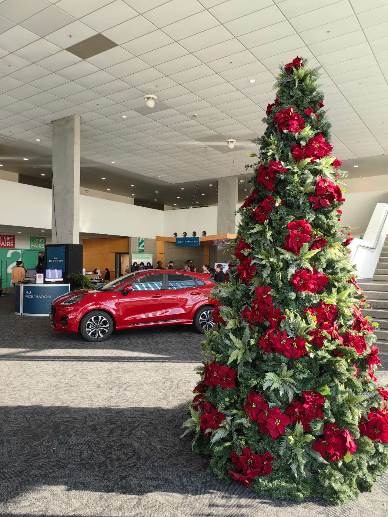 12‘ metal frame green christmas tree with poinsettia & fern decorations 12‘ metal frame green christmas tree with poinsettia & fern decorations