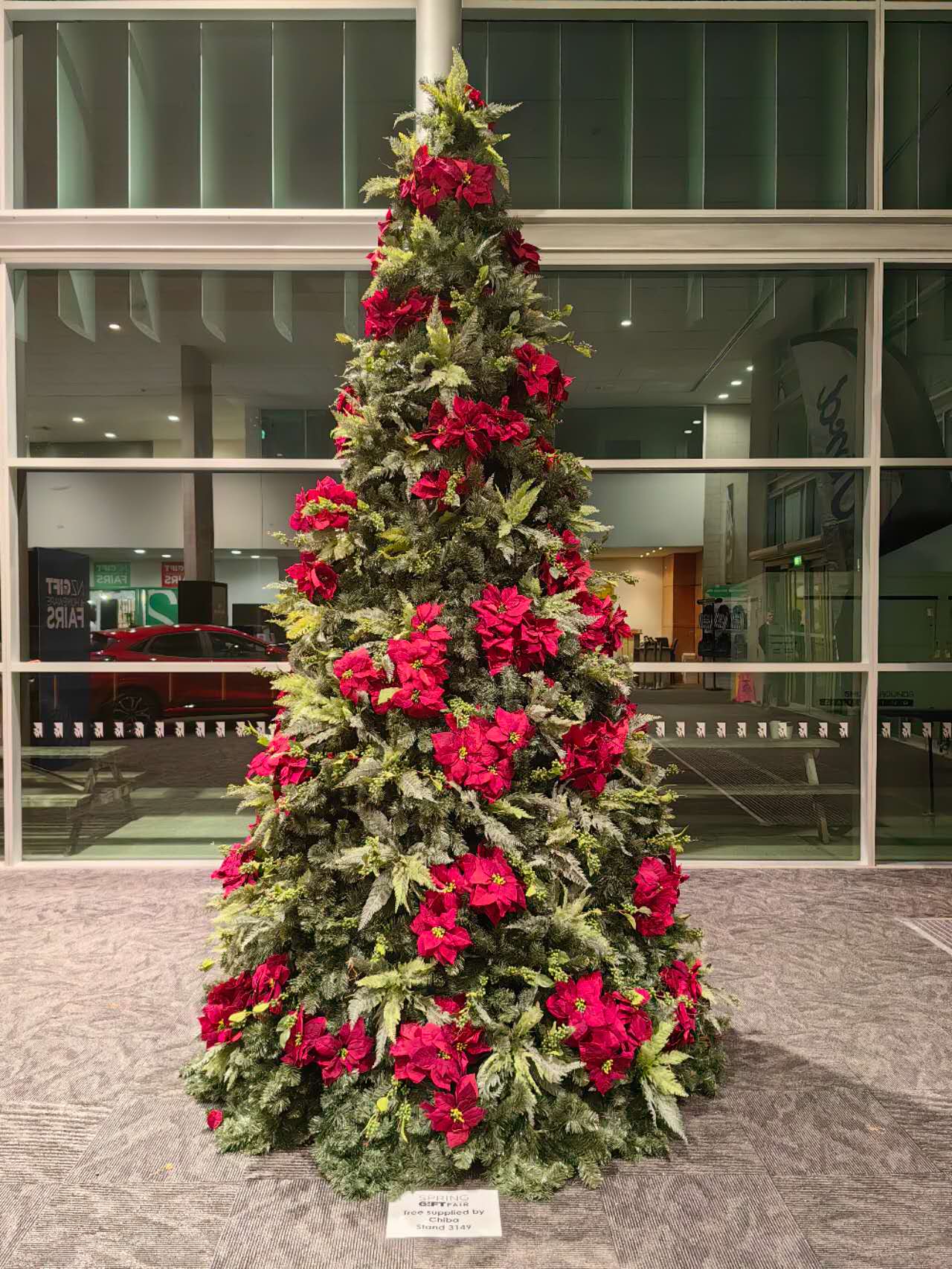 12‘ metal frame green christmas tree with poinsettia & fern decorations 12‘ metal frame green christmas tree with poinsettia & fern decorations